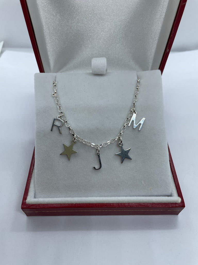 Silver letter and charm necklace